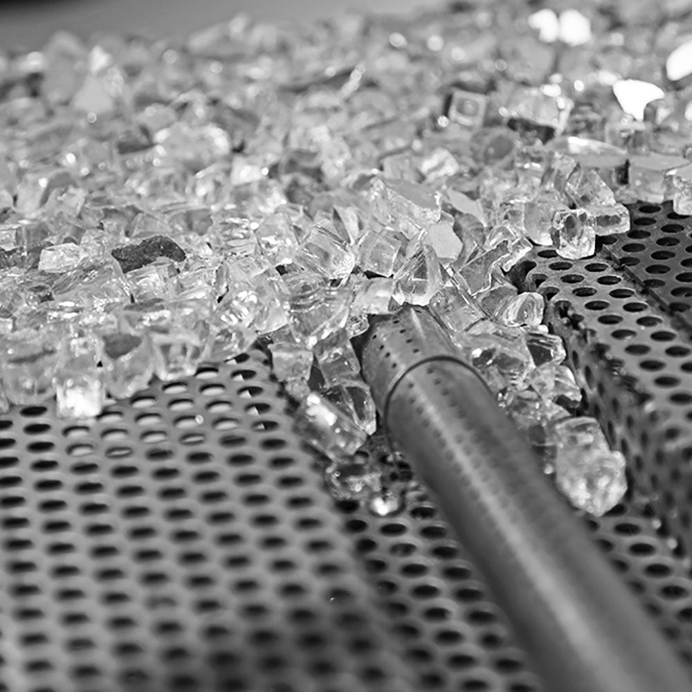 Crushed clear glass over perforated metal burner grate and igniter tube
