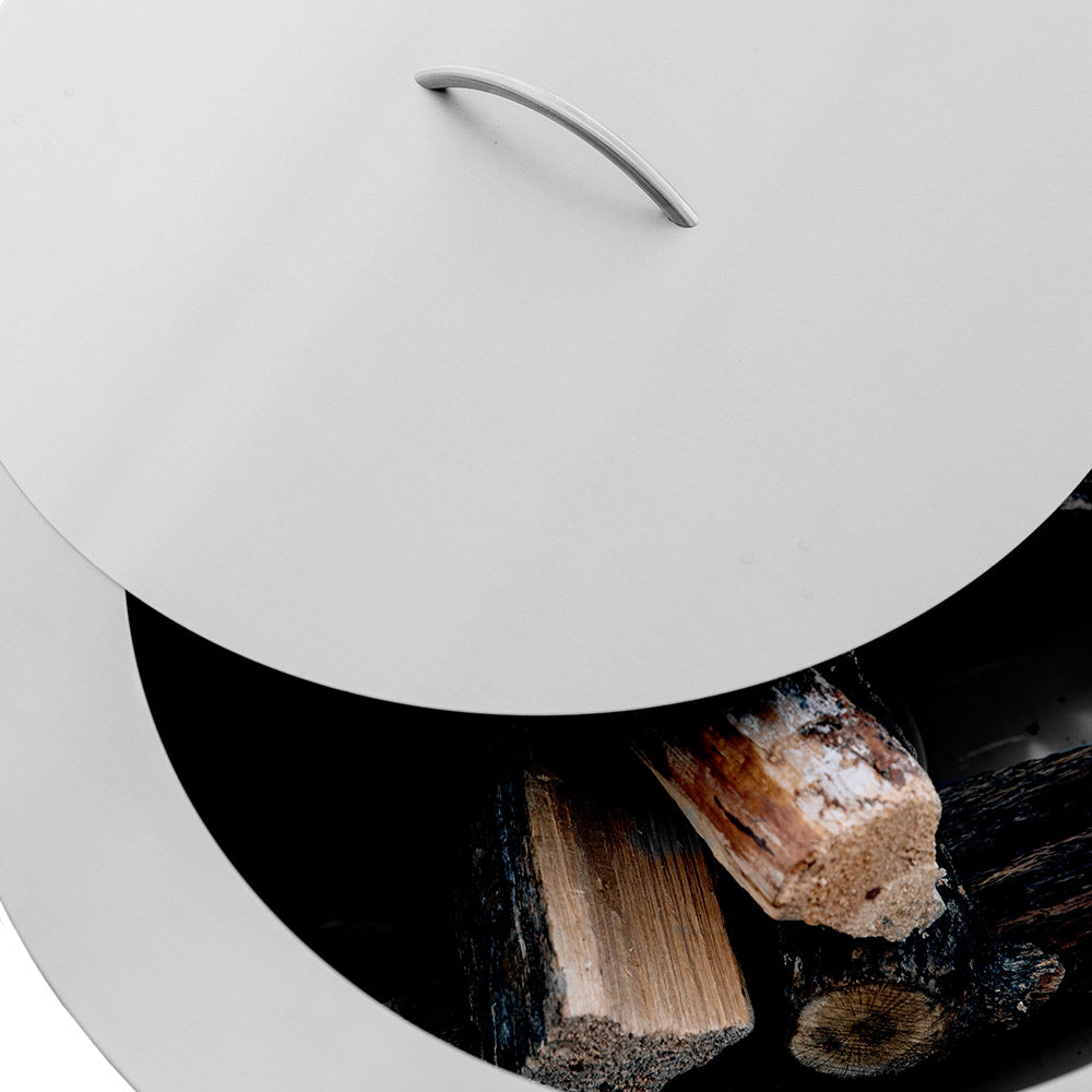 Stainless steel lid with handle over burner opening, showing interior flame and logs