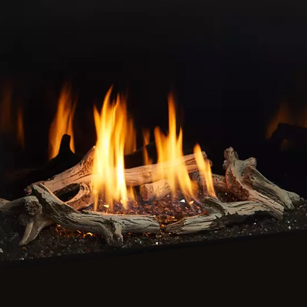 Burning driftwood logs with glowing flames and ember bed