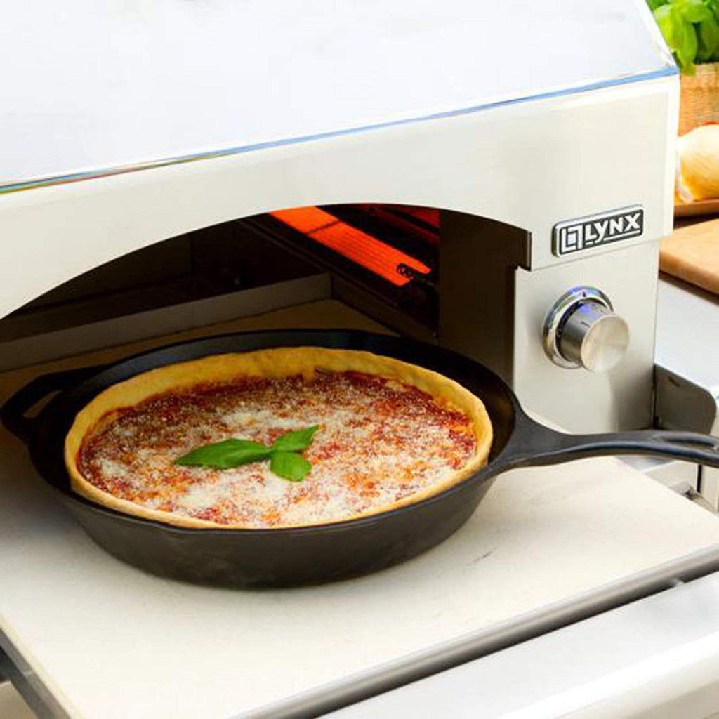 Lynx pizza oven with pizza baking inside the arched cooking chamber