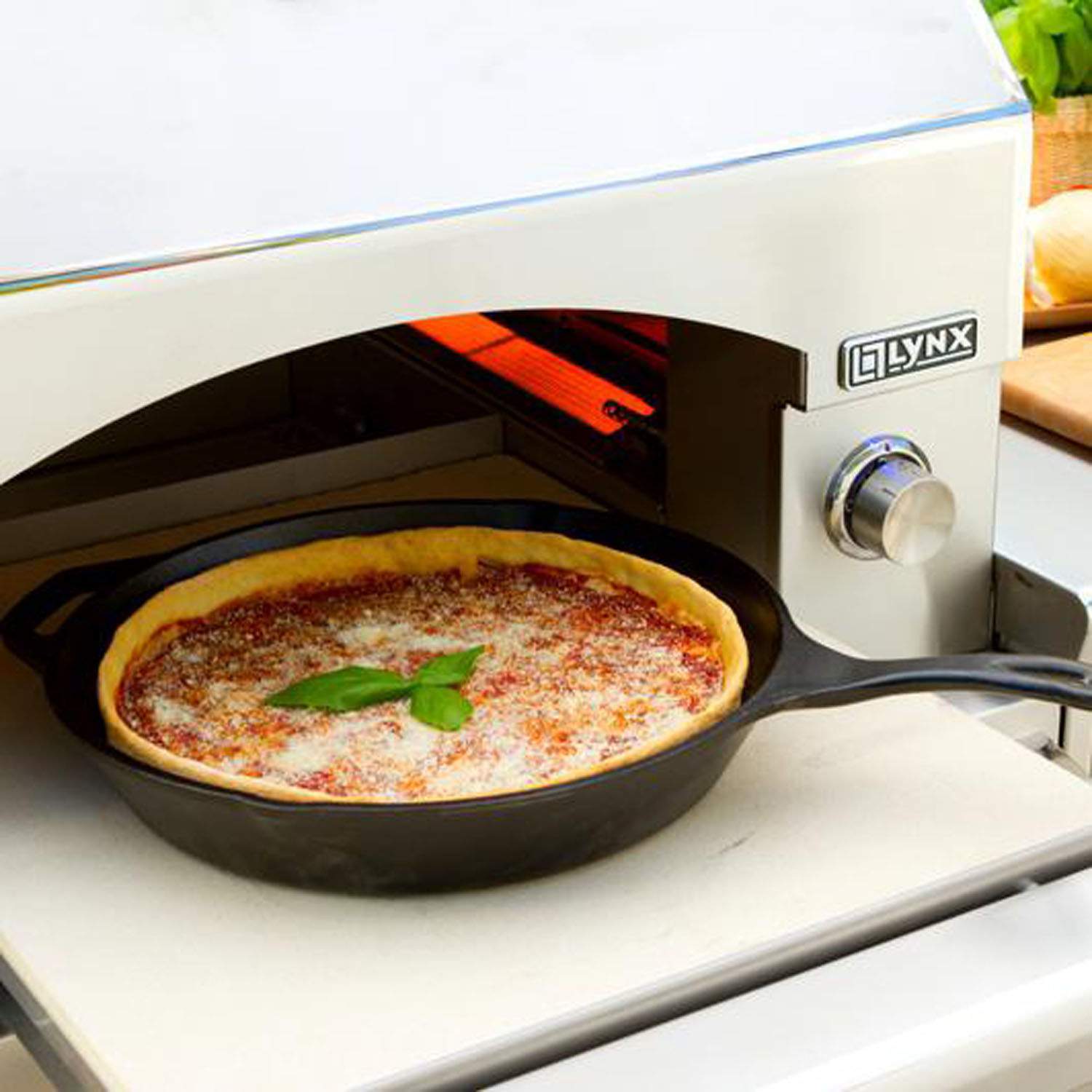 Lynx pizza oven with pizza baking inside the arched cooking chamber