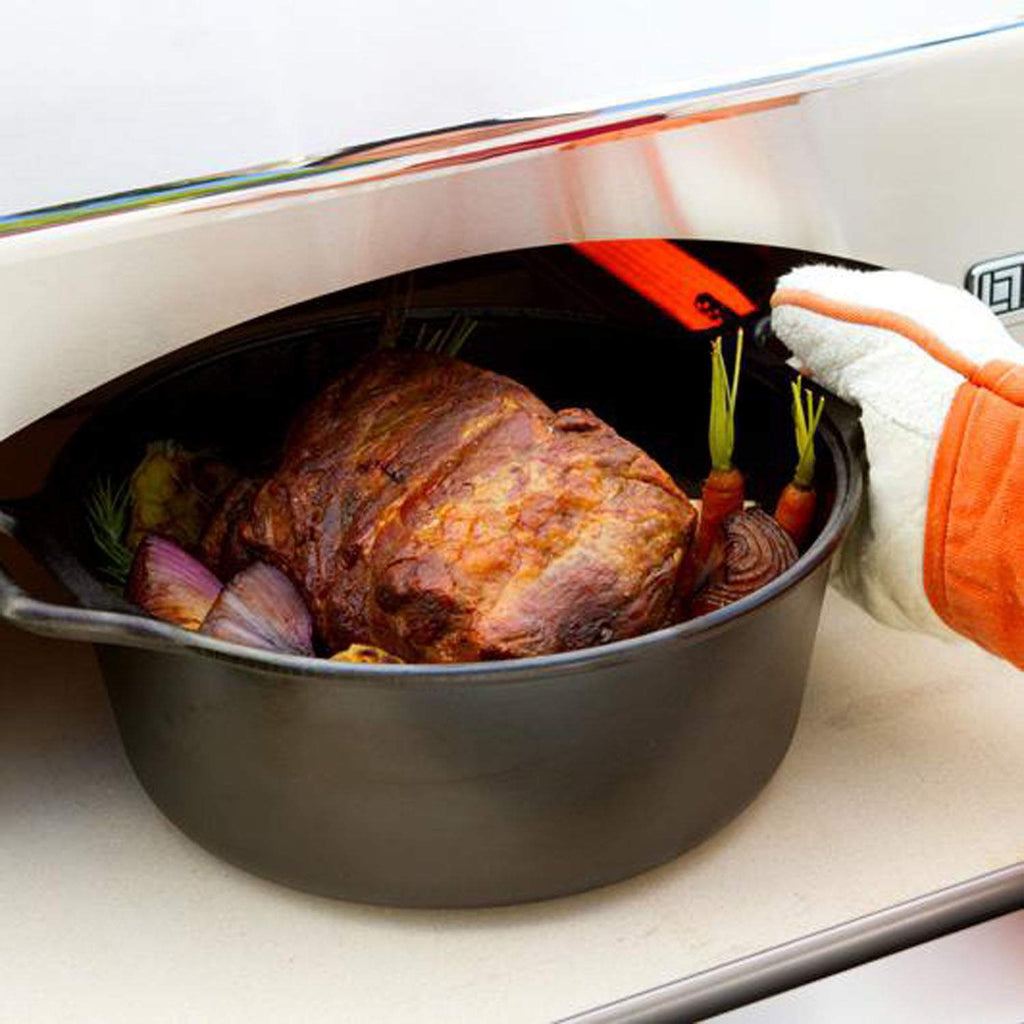 Lynx pizza oven interior with covered roast and vegetables on a baking dish