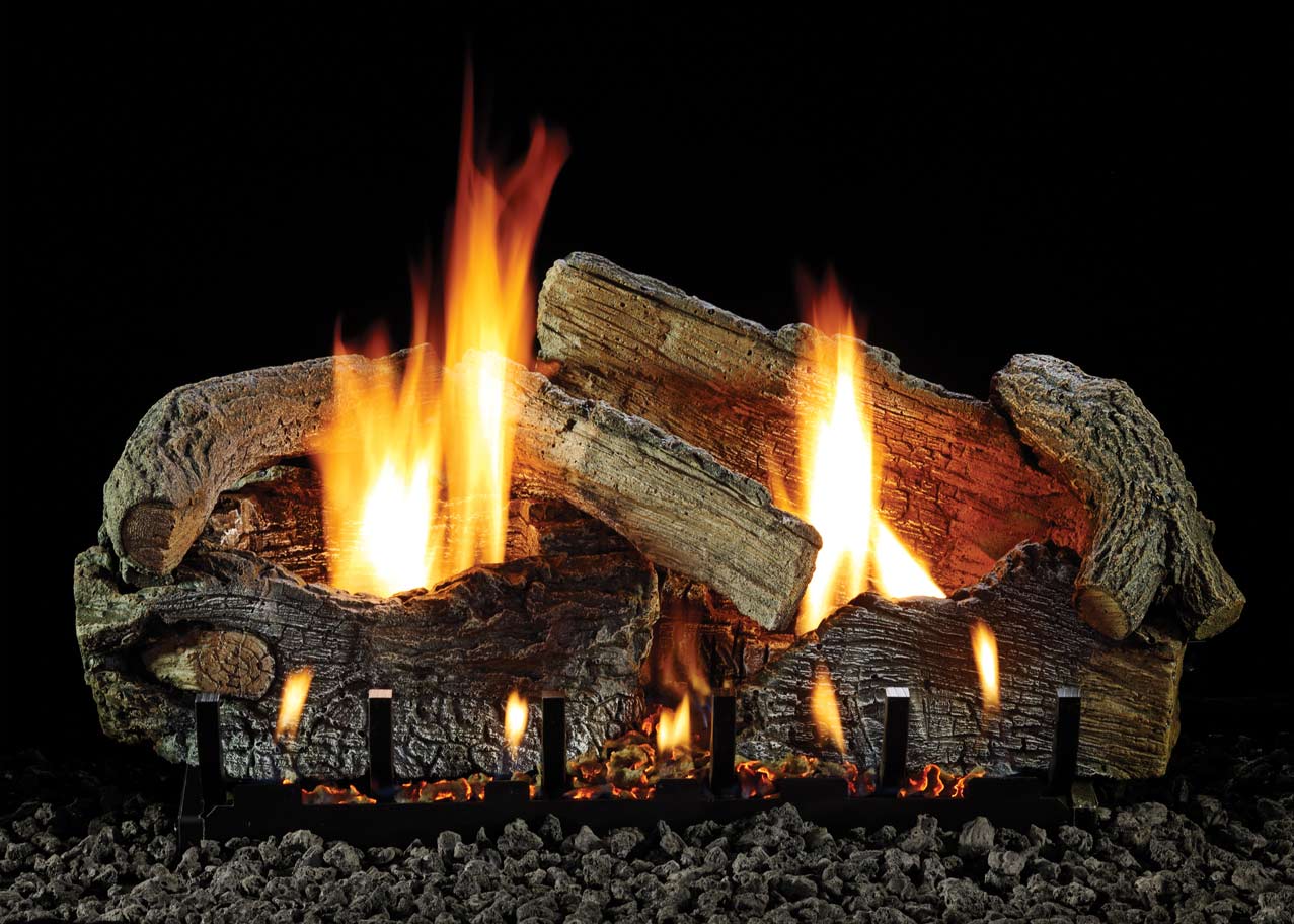 Aged oak gas logs with glowing orange flames and charred log ends