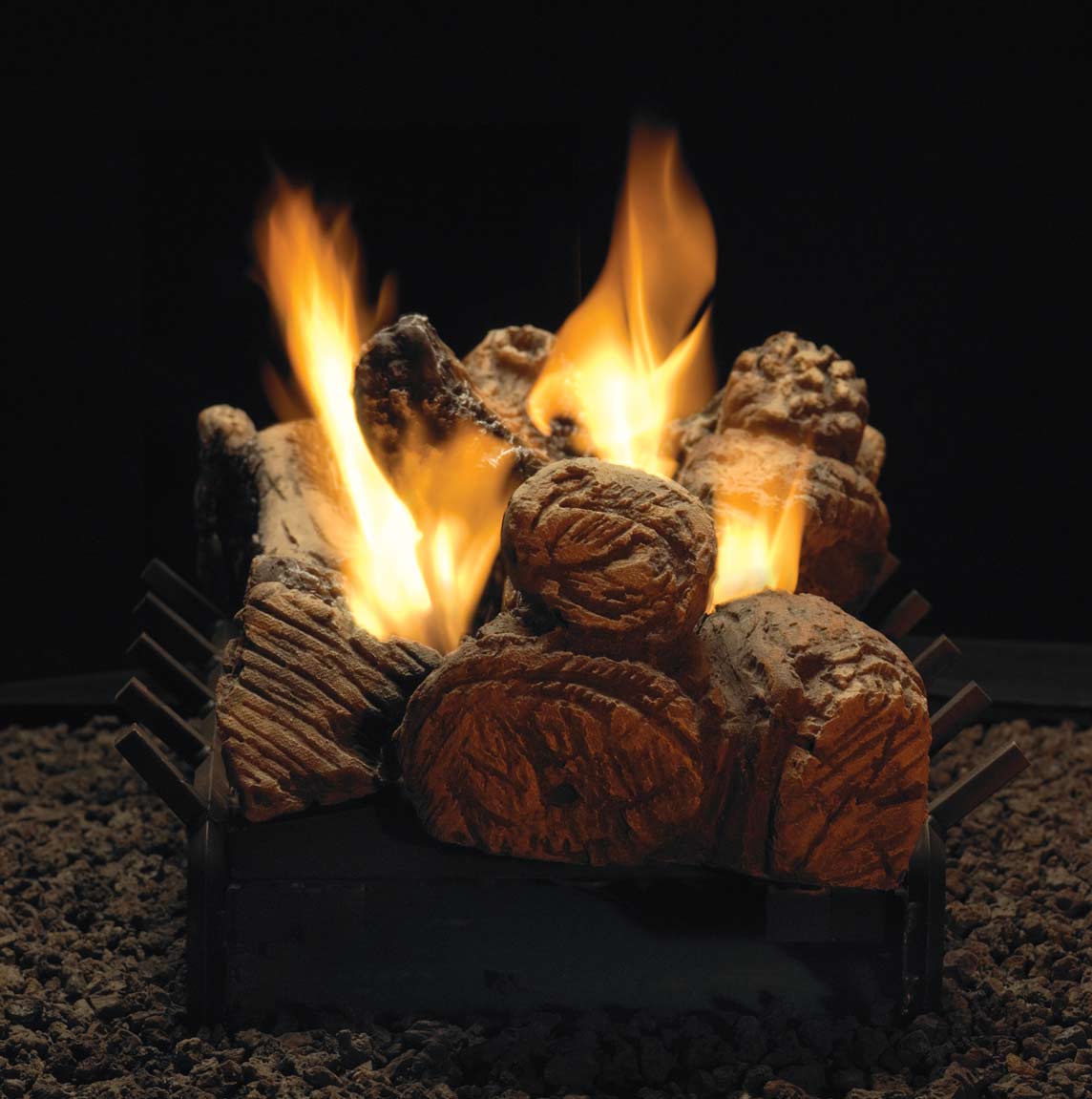 Gas log set with glowing faux logs and tall flames, stacked in black burner