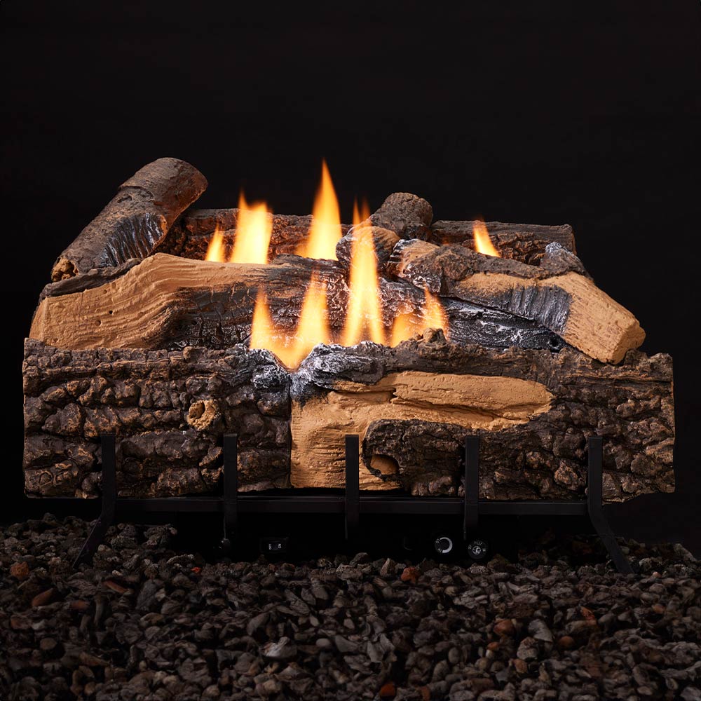 Fireplace log set with burning flames on black metal grate