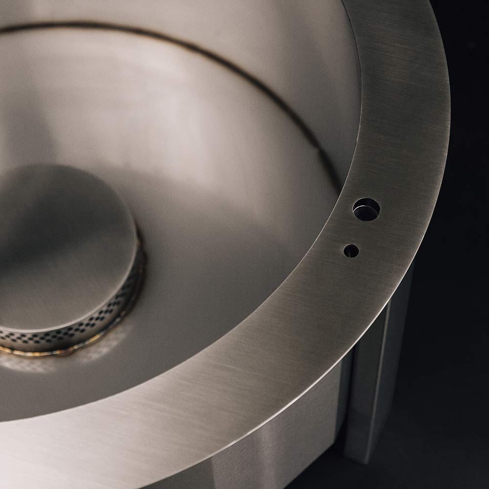 Stainless-style round fire pit bowl with vent holes and curved side wall