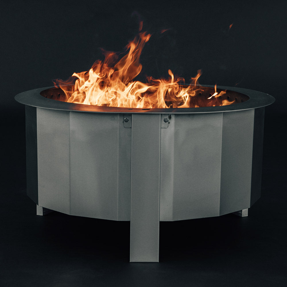 Wood-burning fire pit with visible flames rising above the top opening