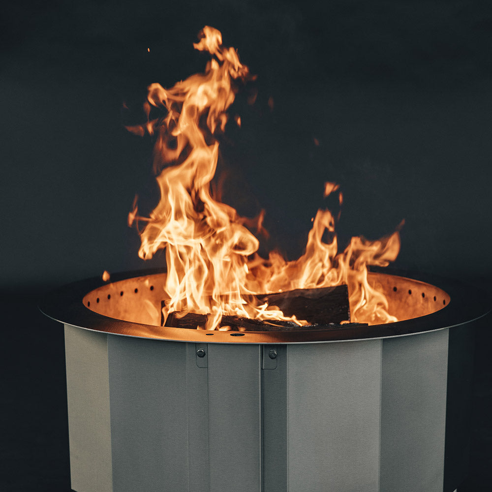 Smokeless wood fire pit flame with logs burning in the center
