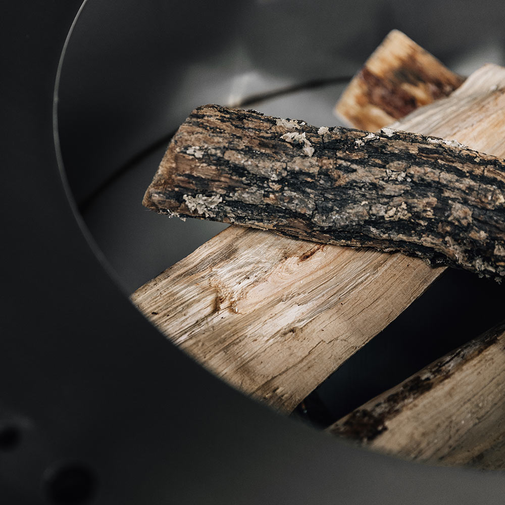 Wood logs in the fire pit burn chamber