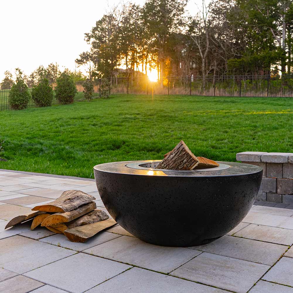 Dark GFRC wood fire bowl with smokeless stainless insert and logs