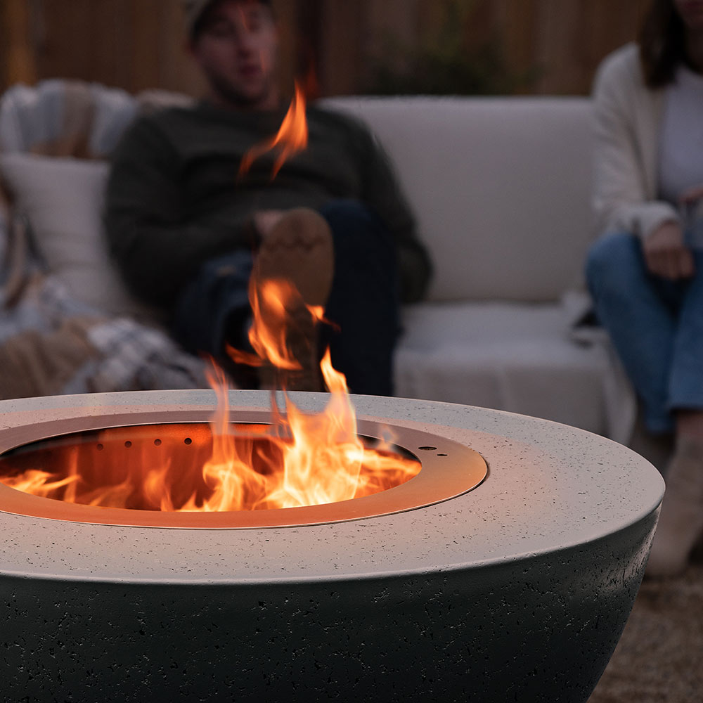 Dark speckled fire bowl top opening with stainless steel insert, flames rising