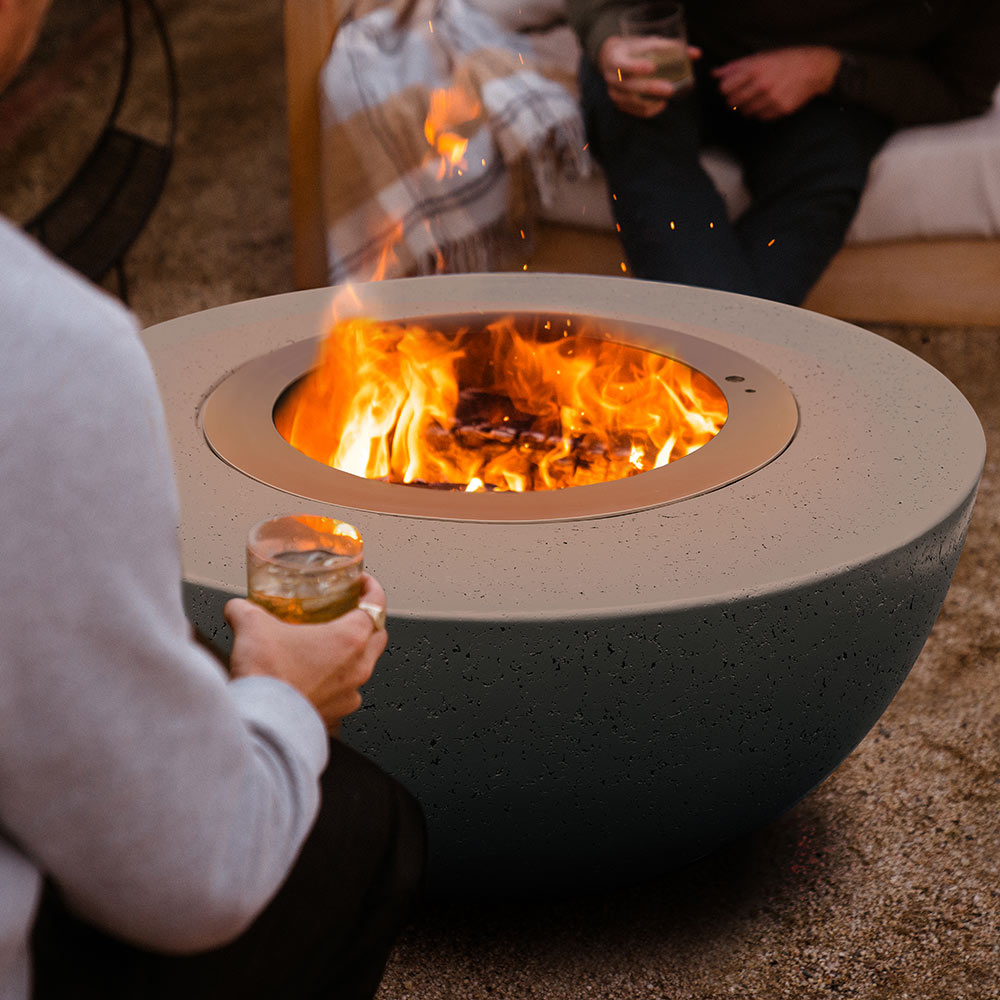 Dark speckled concrete fire bowl with stainless steel smokeless insert, bright flames