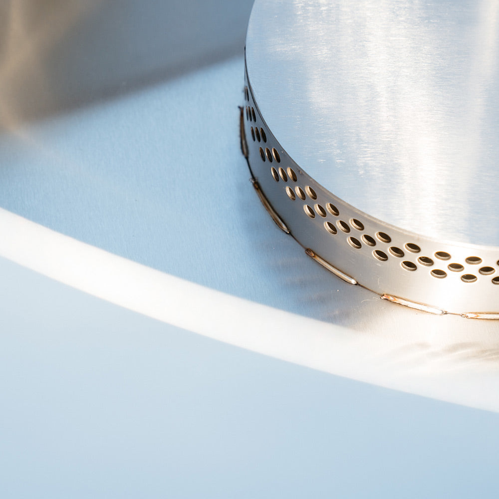 Stainless steel smokeless insert rim with vent holes inside dark GFRC fire bowl