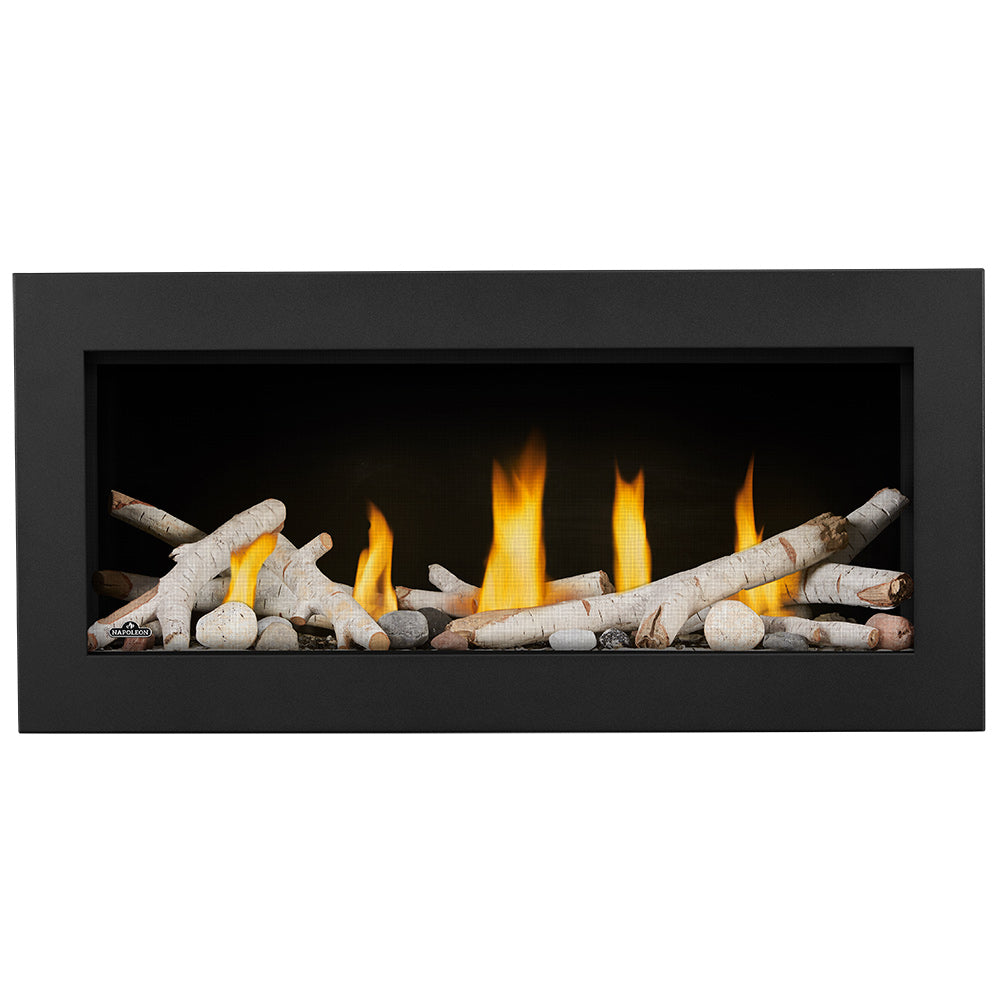 Gas fireplace with beige logs and bright flames inside a black glass-front frame