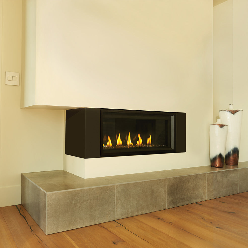 Built-in gas fireplace with burning flames and a dark front panel set in light stone