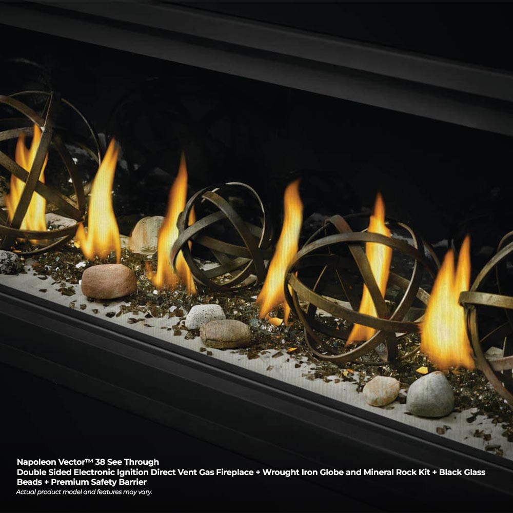 Gas fireplace with metal globe decor and flames over gravel media in black firebox