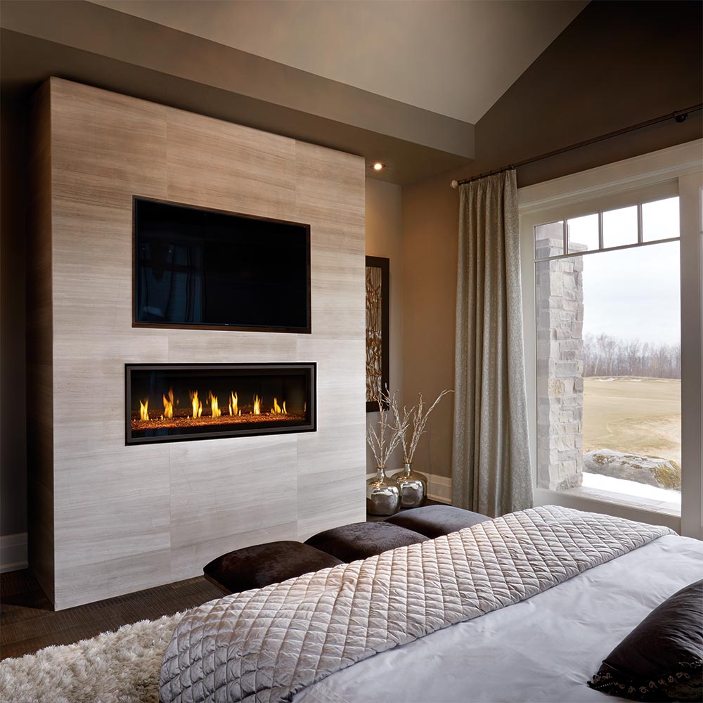 Built-in rectangular gas fireplace with black trim, flames visible in a wall opening