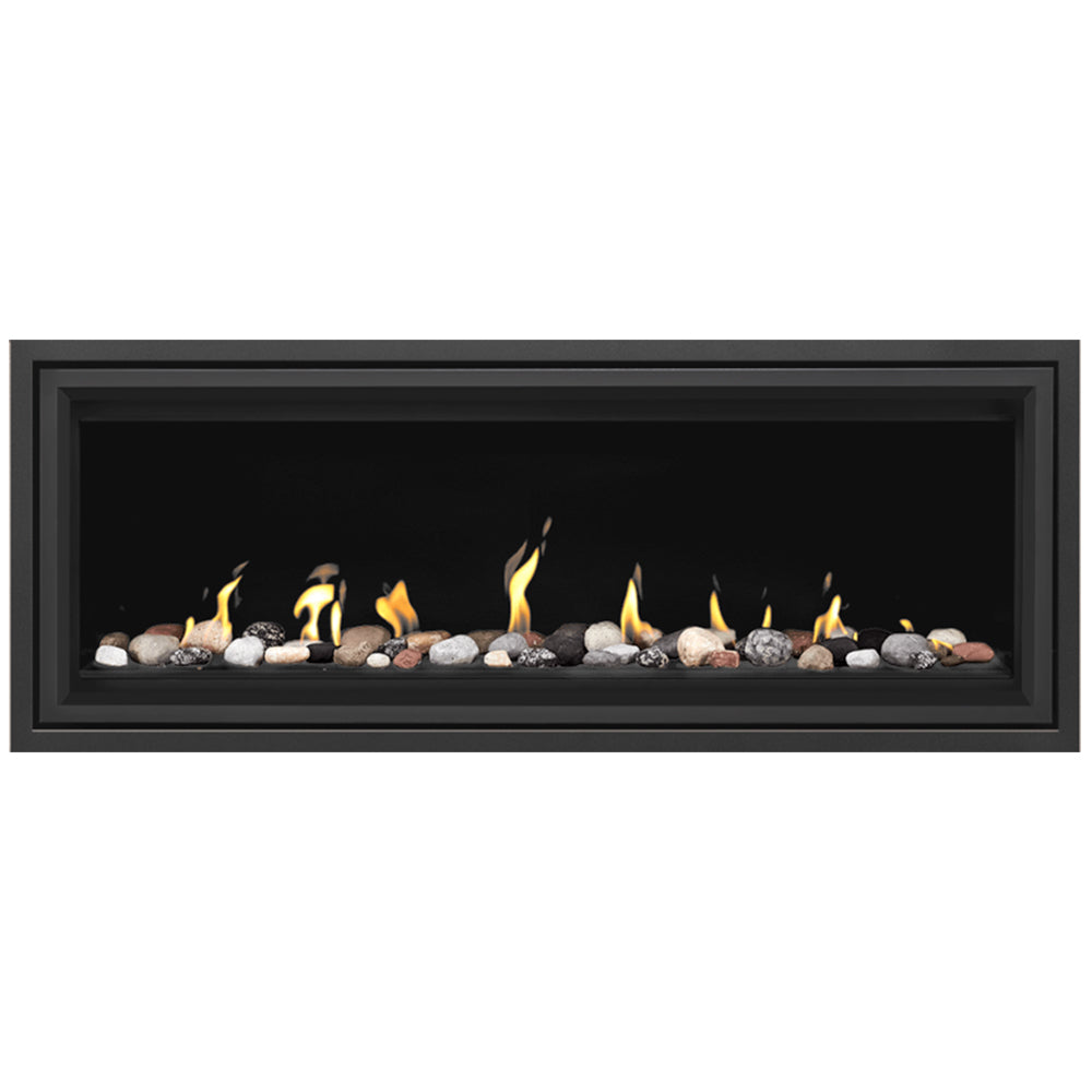 Linear direct vent gas fireplace with mixed media stones and logs, yellow flames visible
