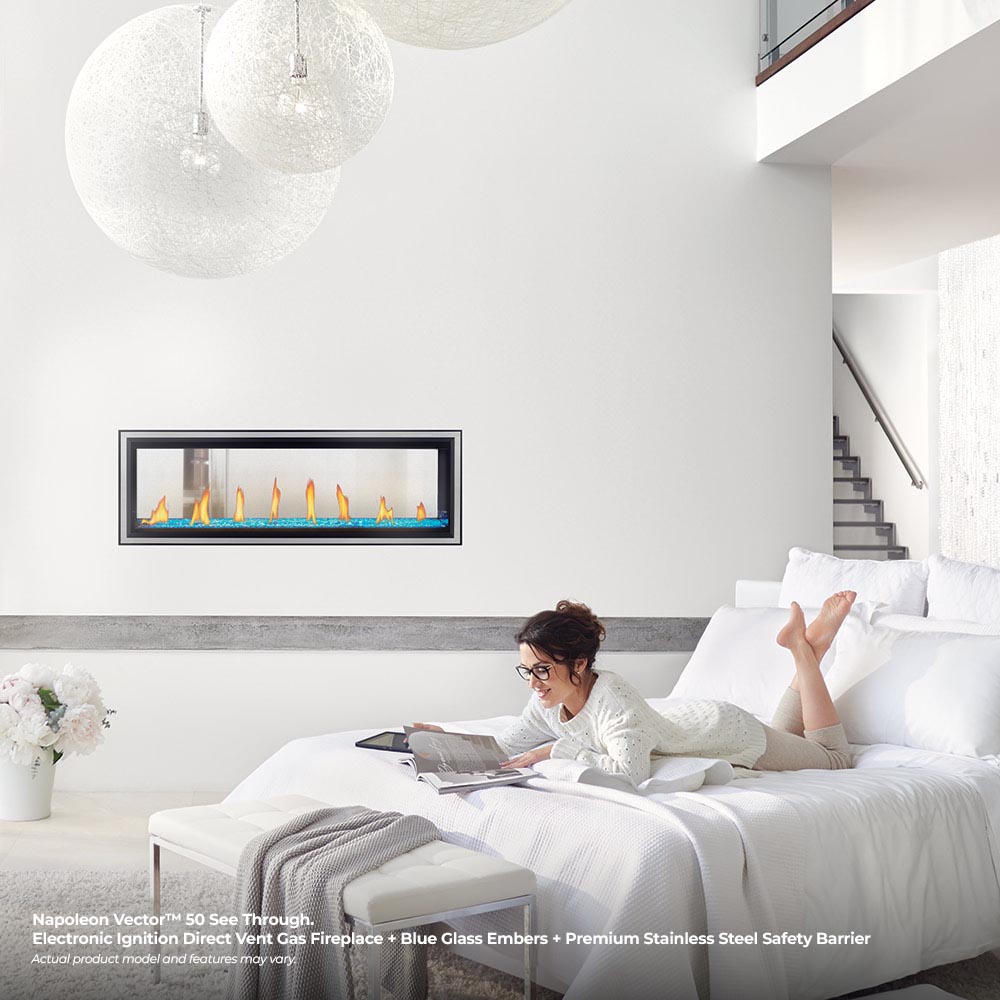 Wall-mounted gas fireplace with flames and light log media in glass frame