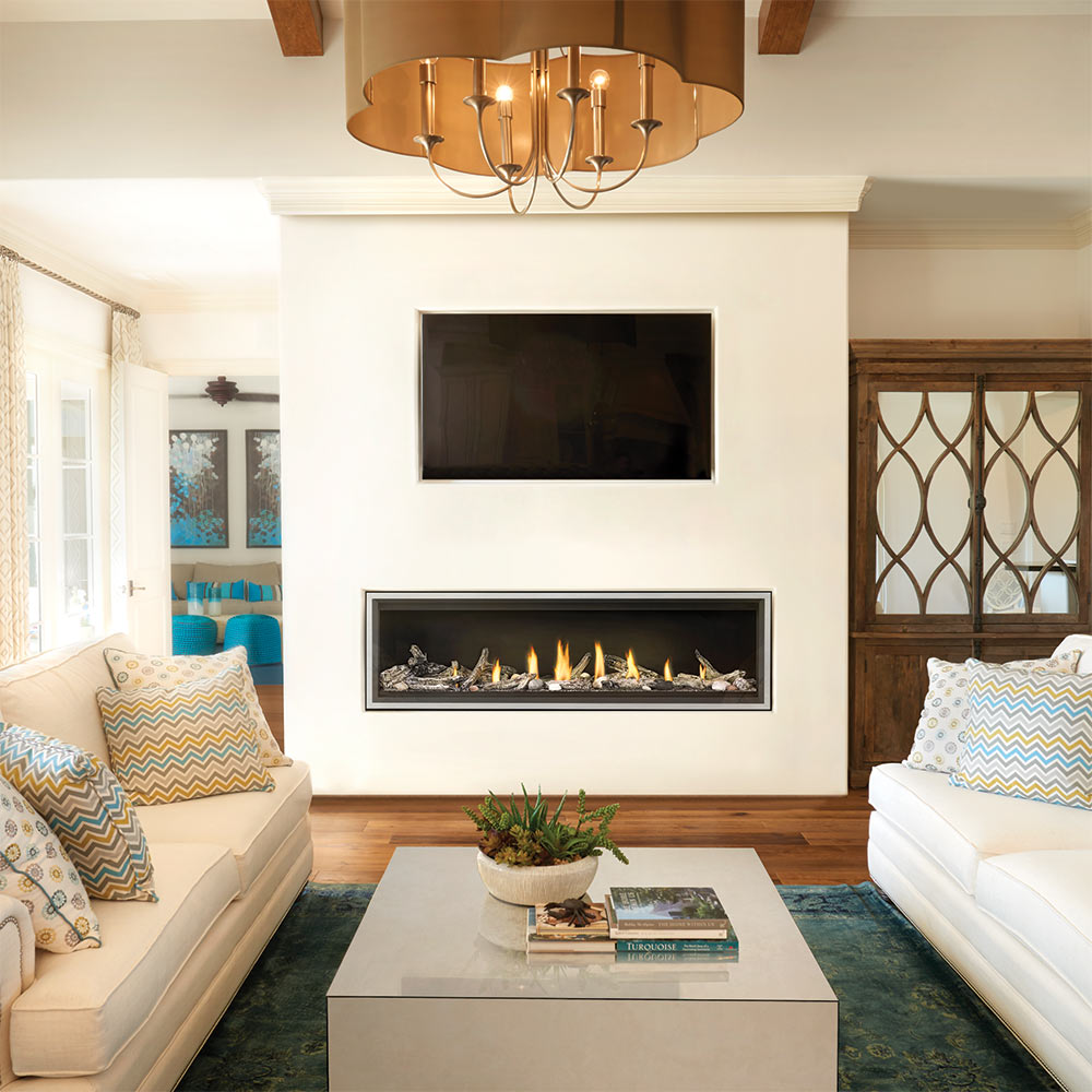 Built-in wall fireplace with black frame and flames in a living room