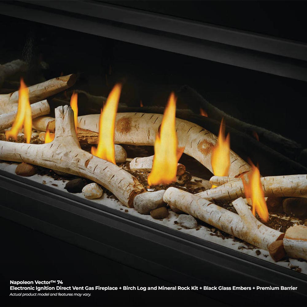 Close-up of a gas fireplace with burning flames over decorative logs and gravel.