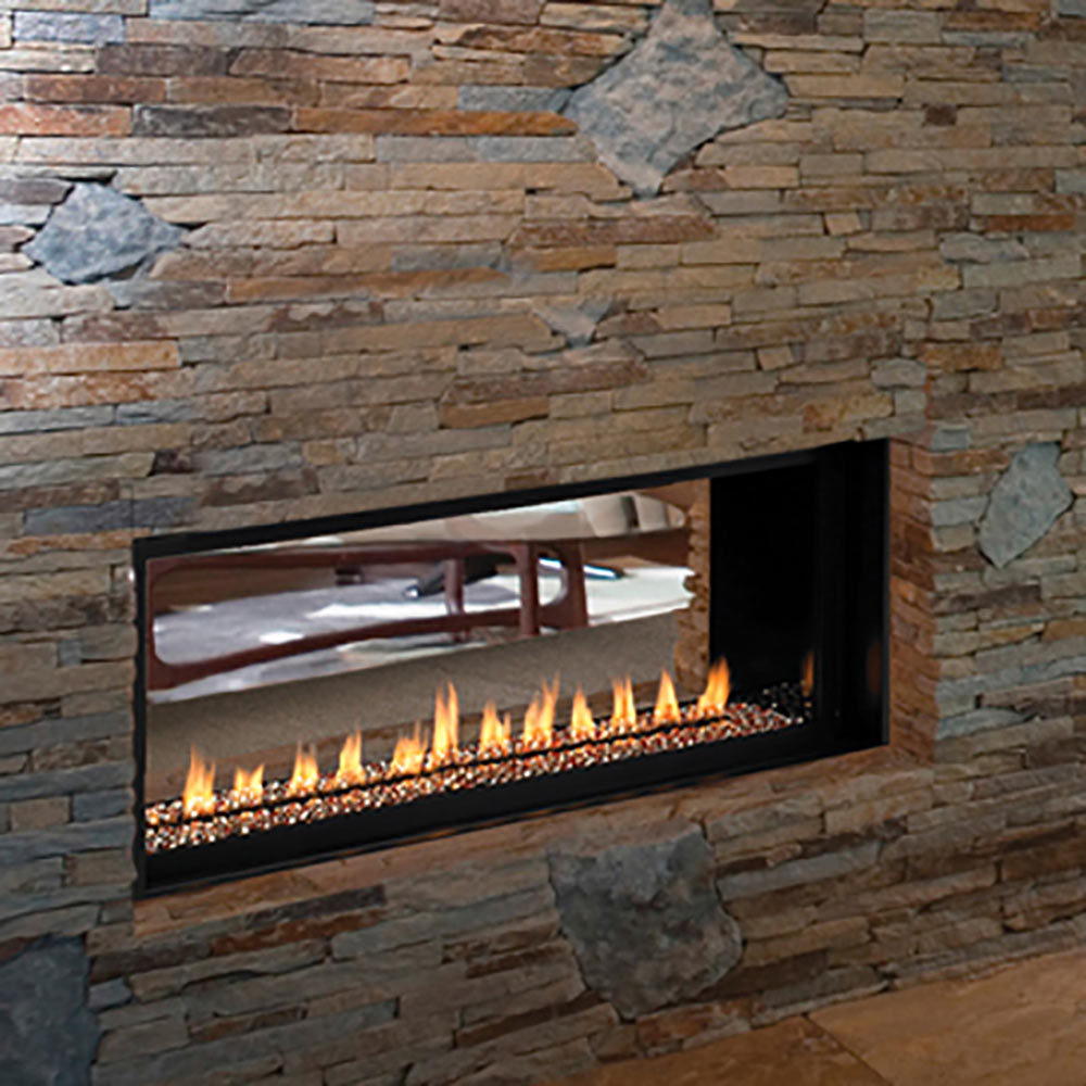 Vent-free see-through conversion kit in a built-in stone fireplace opening with flames