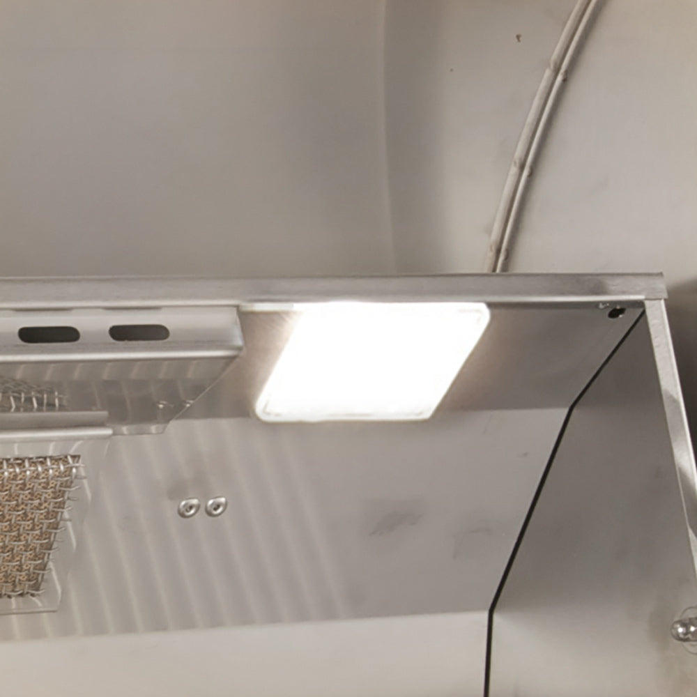Vented stainless interior with built-in overhead light inside the grill hood
