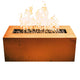 Linear gas fire pit with orange metal finish and flames over lava rocks