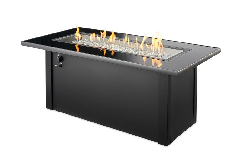 Black gas fire table with rectangular glass firebox and visible flames