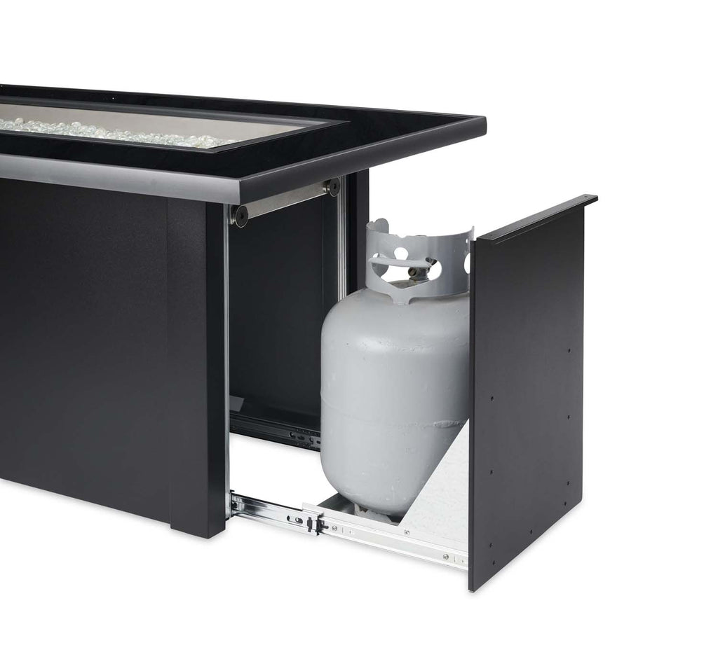 Black gas fire table with side access door open, showing propane tank