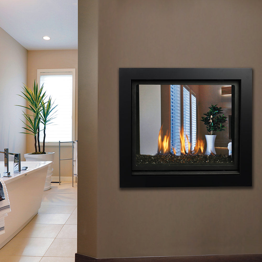 Black-framed see-through gas fireplace showing burning flames and log bed
