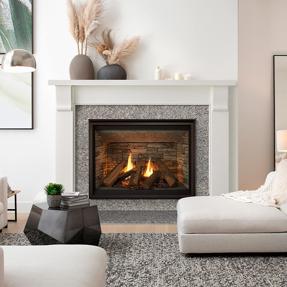Stone-surround direct vent gas fireplace with logs and flames behind dark glass