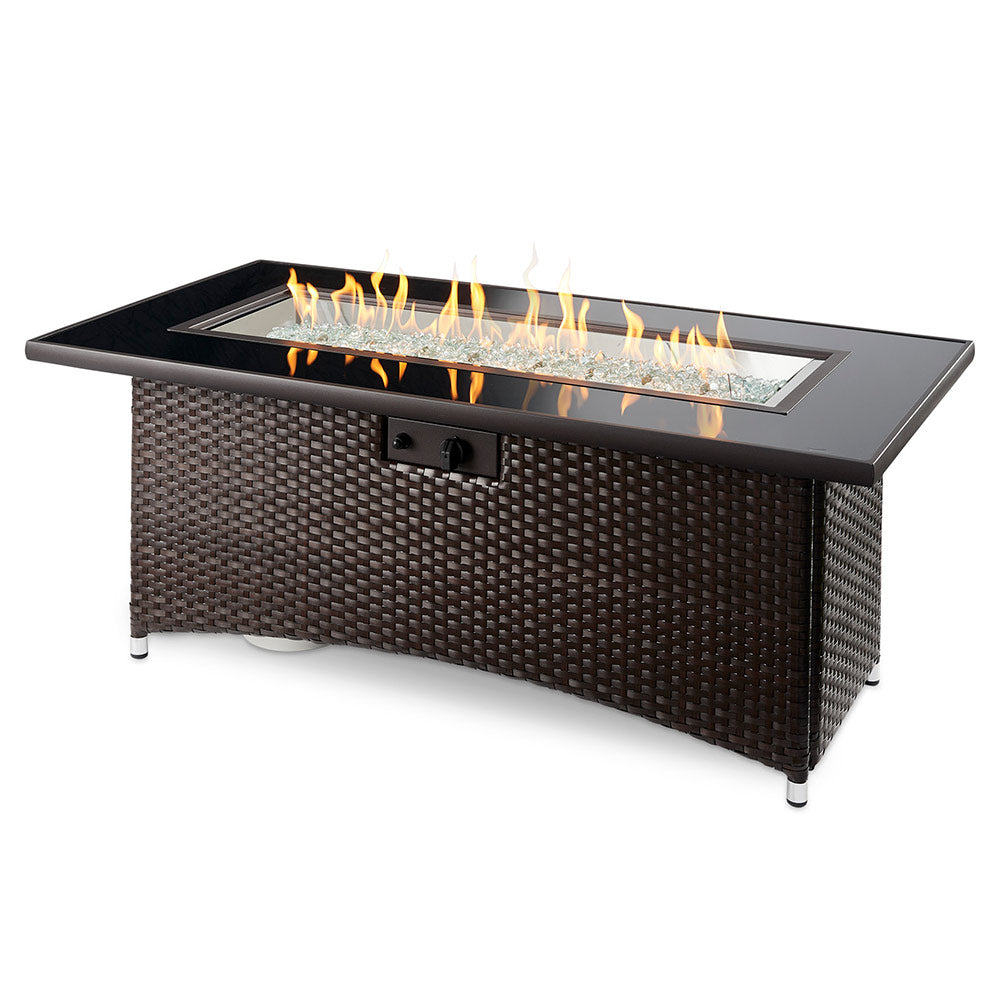 Woven dark brown outdoor gas fire table with black burner cover and raised glass panel