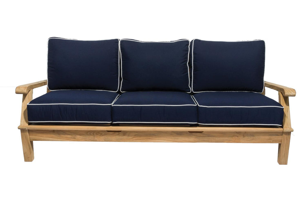 Teak outdoor sofa with navy cushions and three back pillows