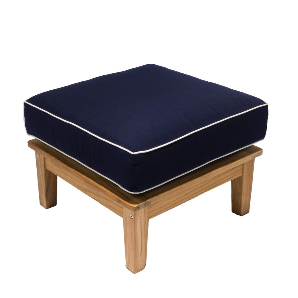 Square outdoor ottoman with deep navy cushion and white piping, natural wood legs