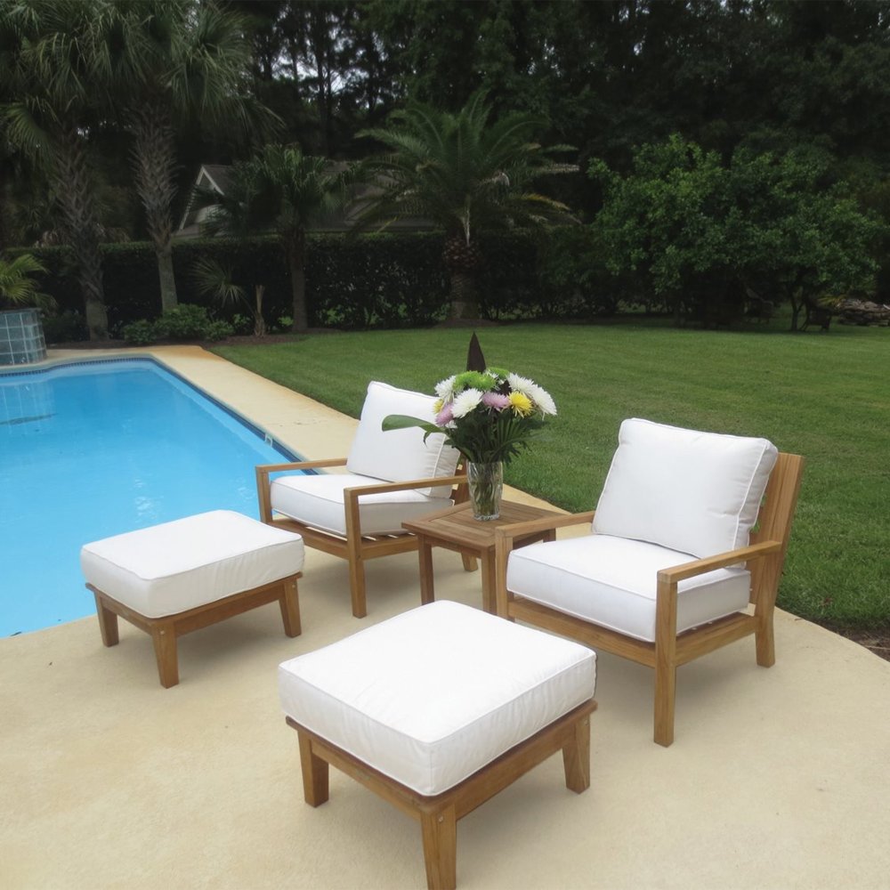 Outdoor ottoman with white cushion and natural wood frame, shown with seating nearby