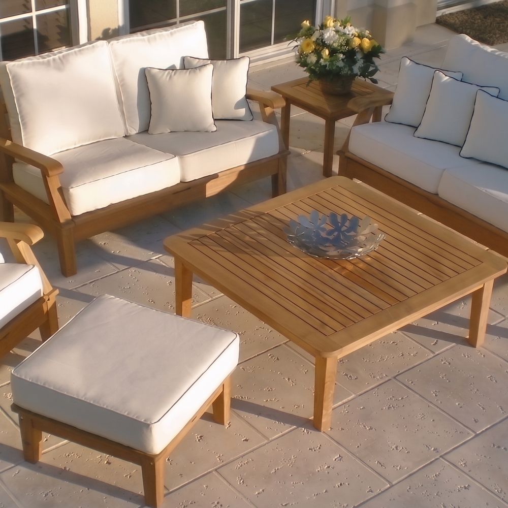 Outdoor teak ottoman with light canvas seat cushion