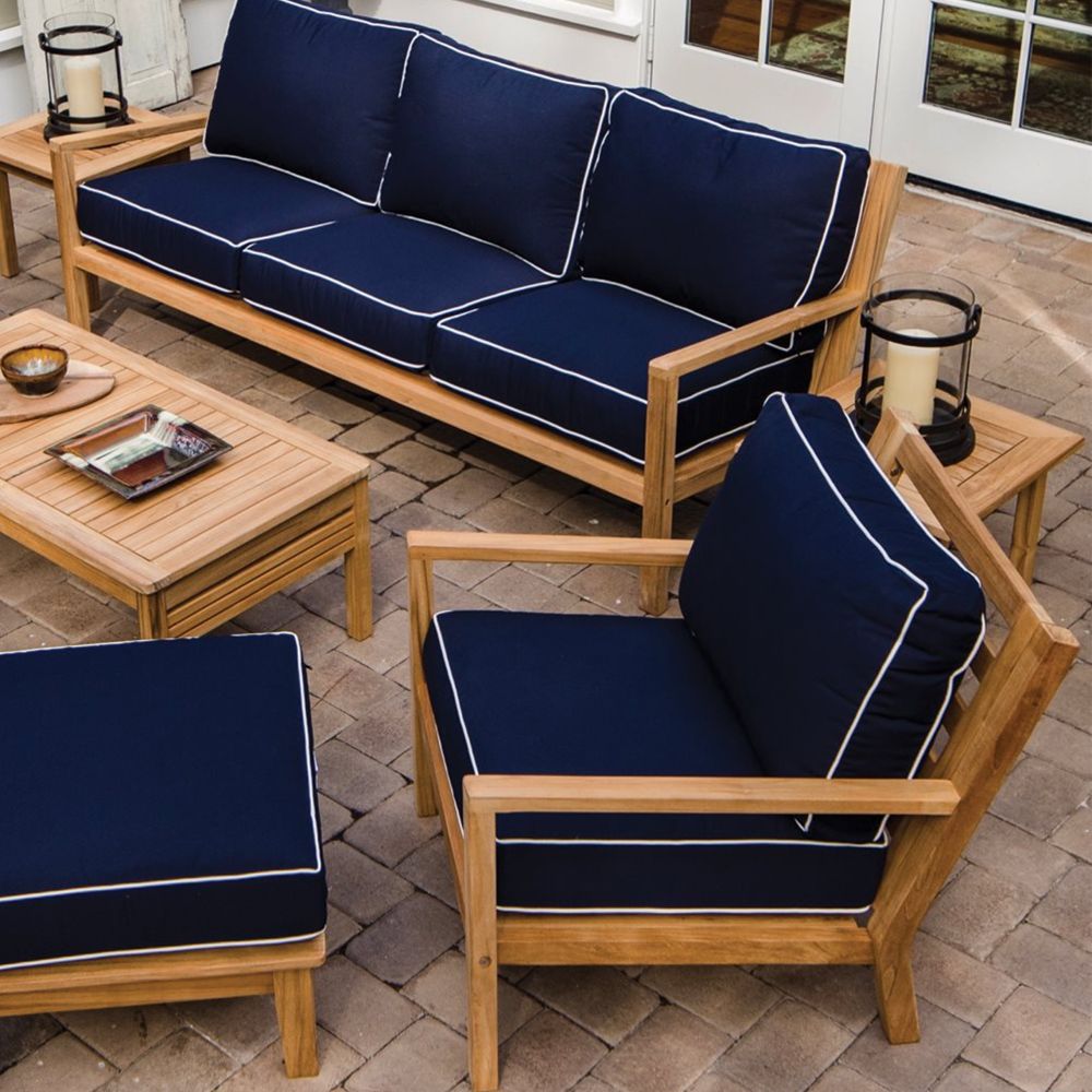 Outdoor teak ottoman with navy canvas seat cushion