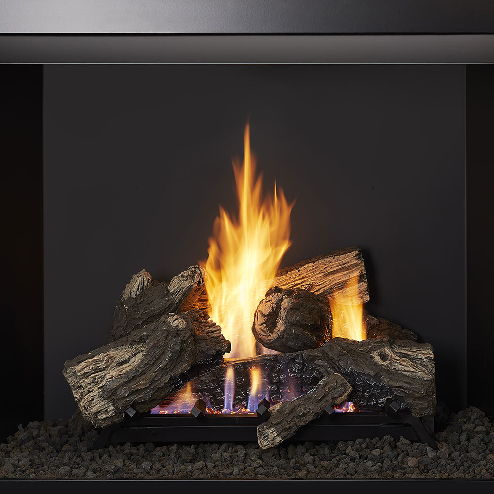 Vent-free gas log set with stacked logs and bright flames over glowing embers