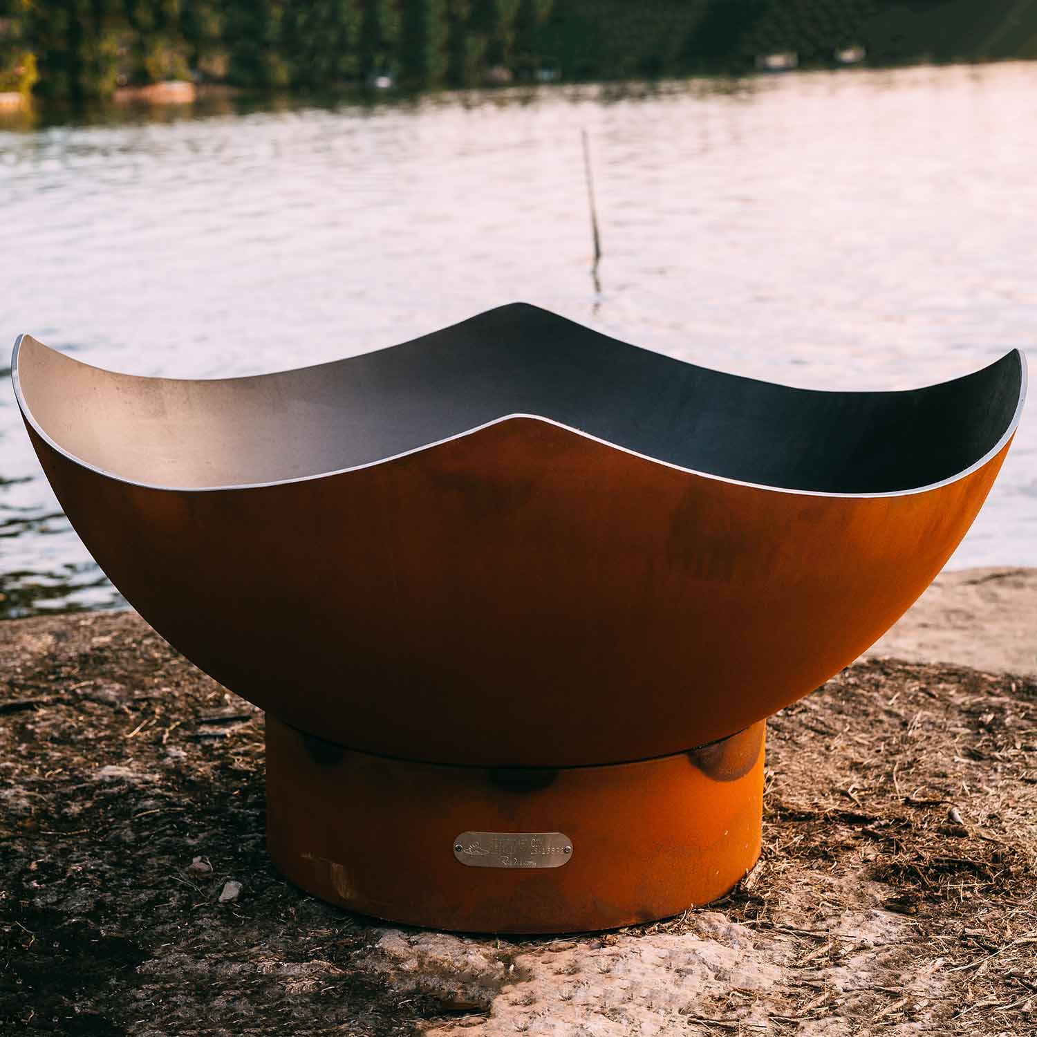 Bronze manta ray gas fire pit with dark interior bowl and small front vent slot