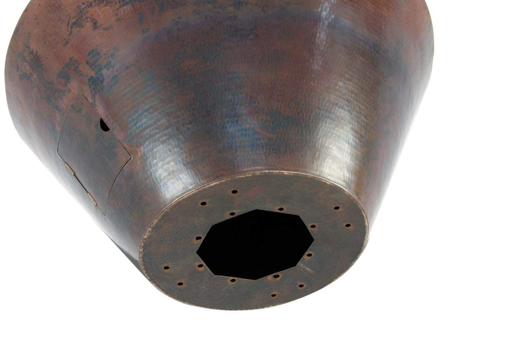 Underside of hammered copper gas fire bowl with circular burner base and holes