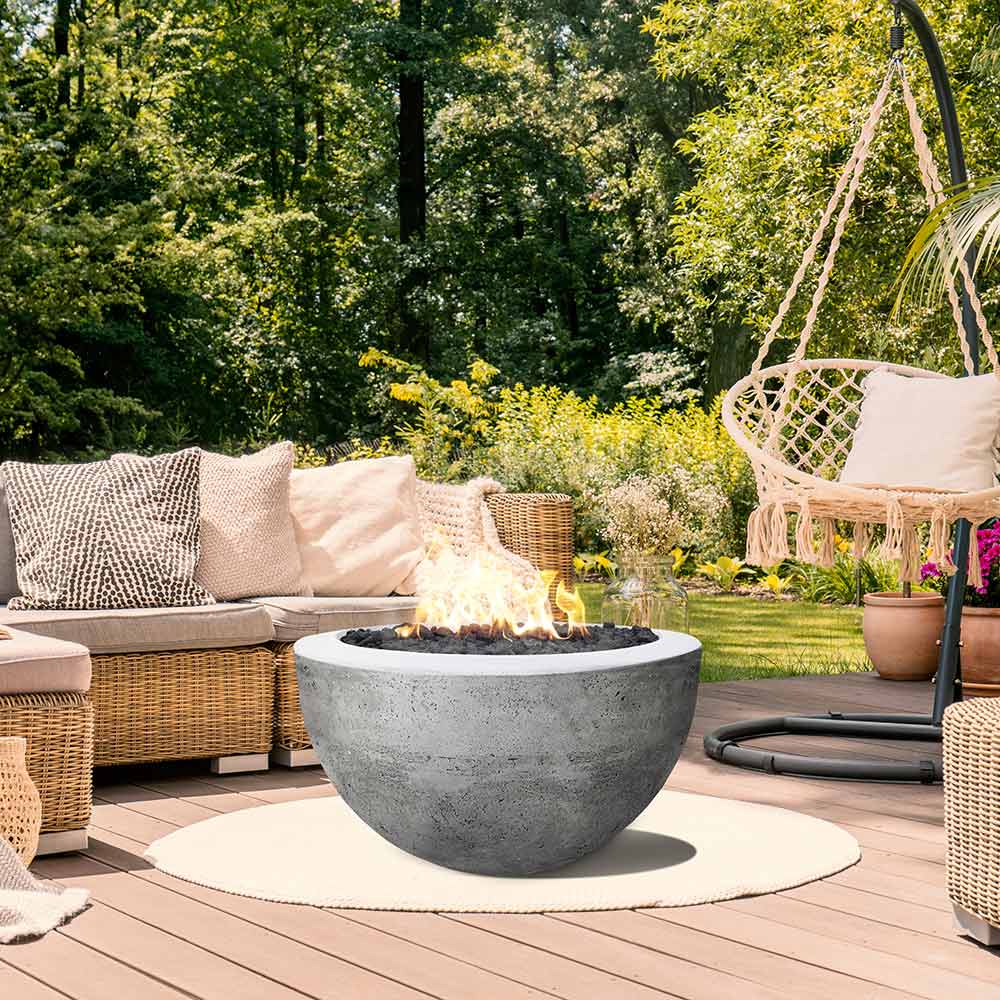 Outdoor concrete gas fire pit bowl in light gray with visible burner opening