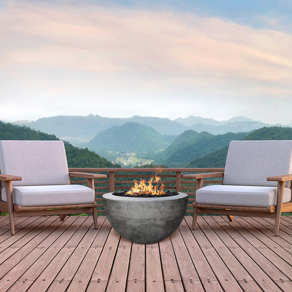 Concrete gas fire pit bowl in dark gray with small flames in burner