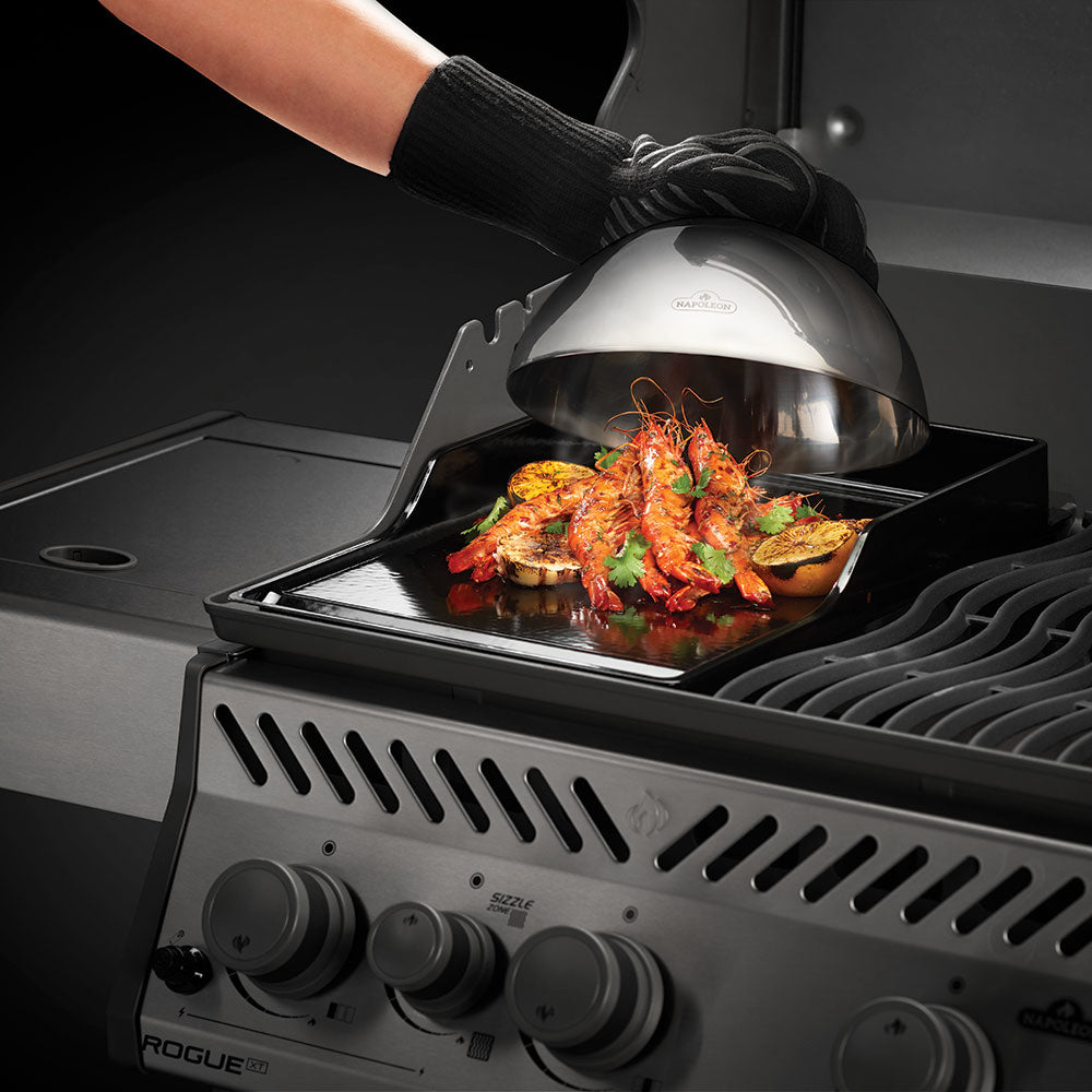 Stainless steel cooking dome with knob over grilled food