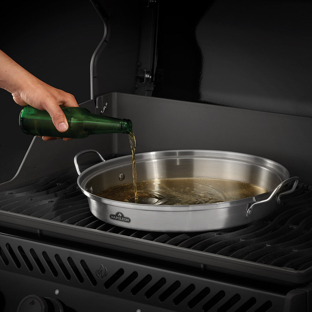 Stainless steel roaster with perforated cup; liquid pouring into the pan