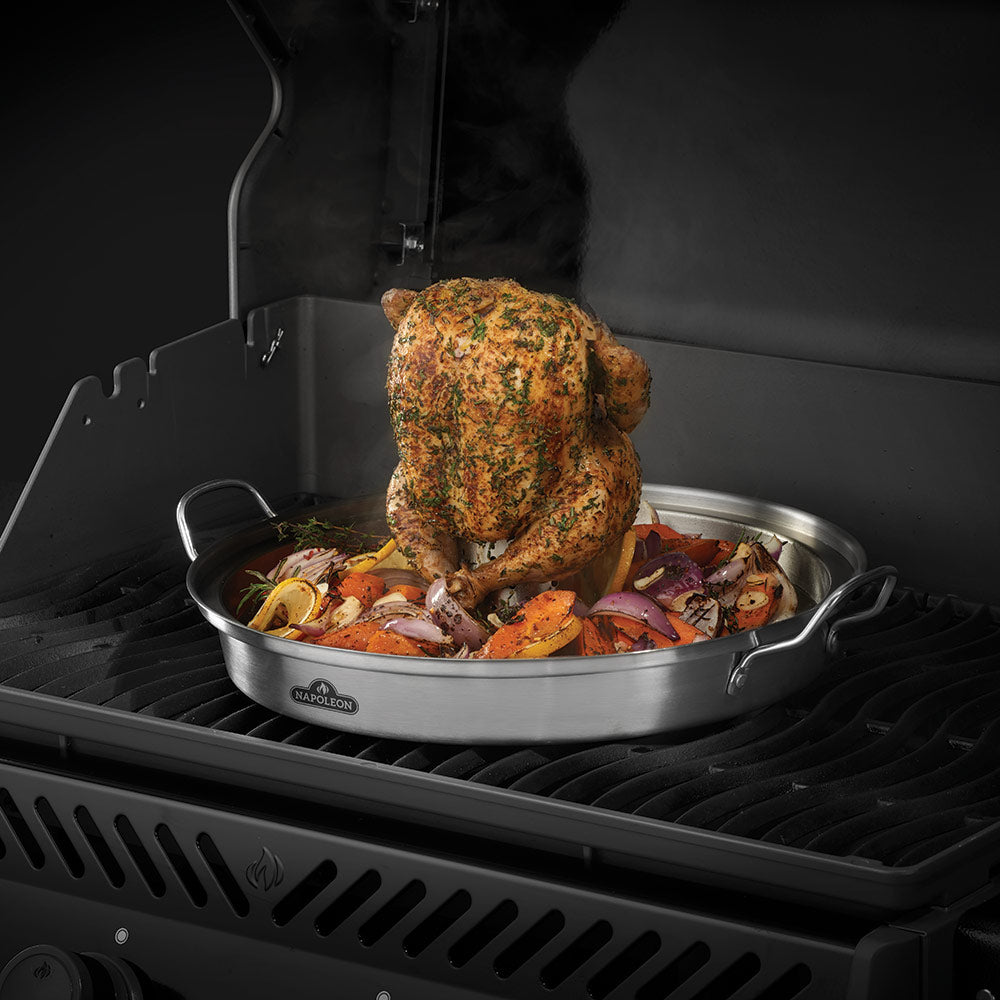 Stainless steel roaster with seasoned chicken and vegetables