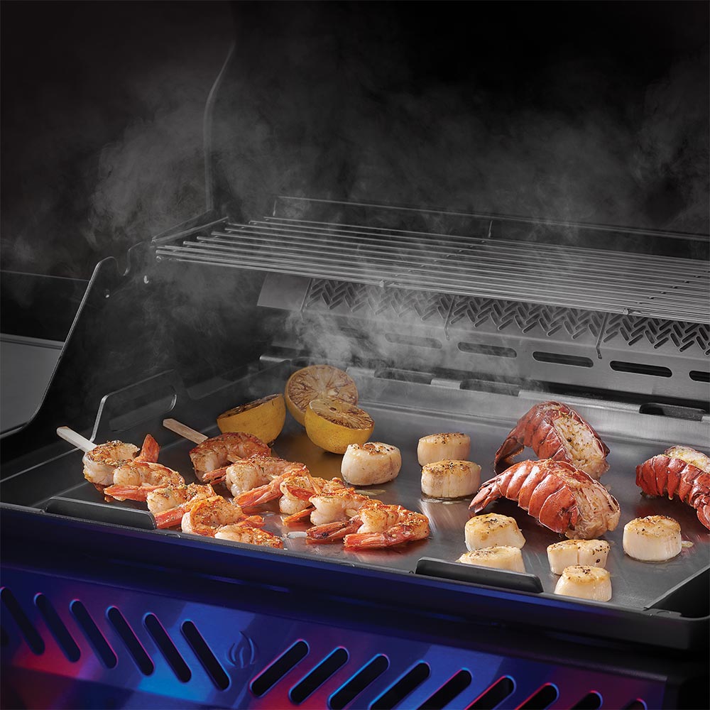 Stainless steel griddle insert in use with cooked food on top surface