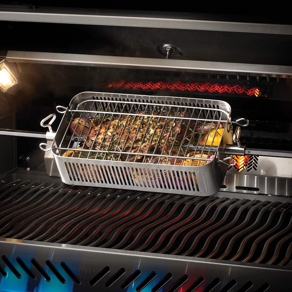 Stainless steel rotisserie basket holding roasted food over grill flames