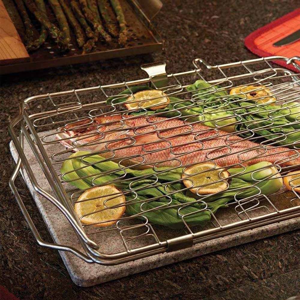 Wire grill basket holding fish and vegetables on grill grate