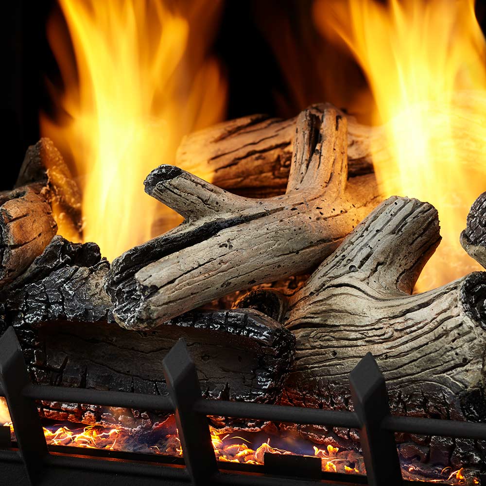 Vent-free gas logs with tall flames behind a black metal safety grate